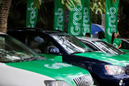 Grab cars are seen during a launch ceremony in Phnom Penh, Cambodia, December 19, 2017. REUTERS/Samrang Pring/Files