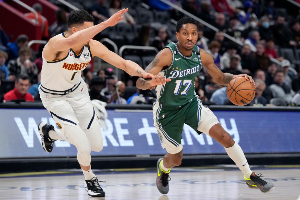 Pistons guard Rodney McGruder drives around Nuggets forward Michael Porter Jr. during the first half on Thursday, March 16, 2023, at Little Caesars Arena.