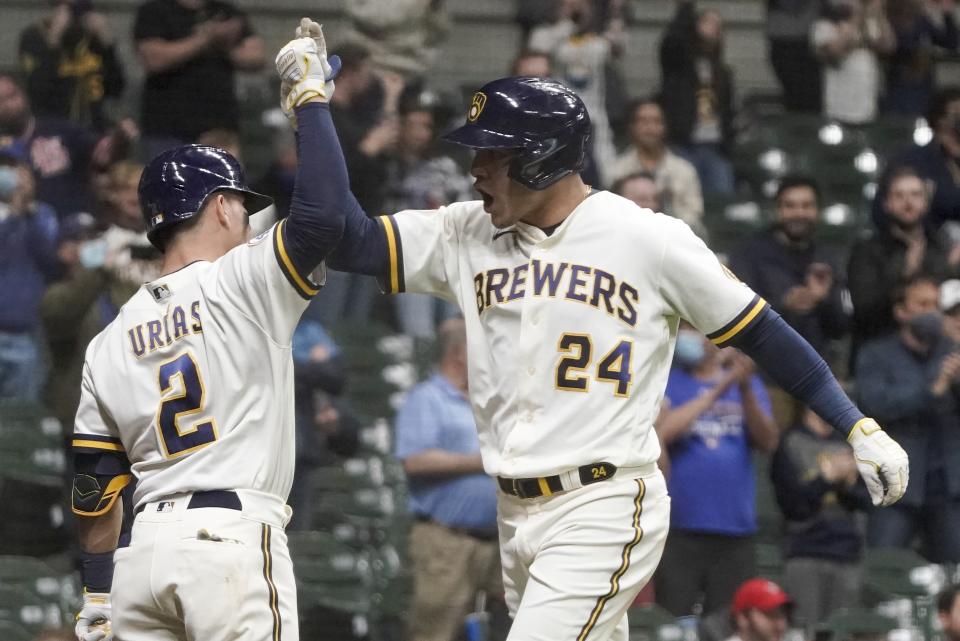 Milwaukee Brewers' Avisail Garcia is congratulated by Luis Urias after hitting a two-run home run during the eighth inning of a baseball game against the St. Louis Cardinals Wednesday, May 12, 2021, in Milwaukee. (AP Photo/Morry Gash)