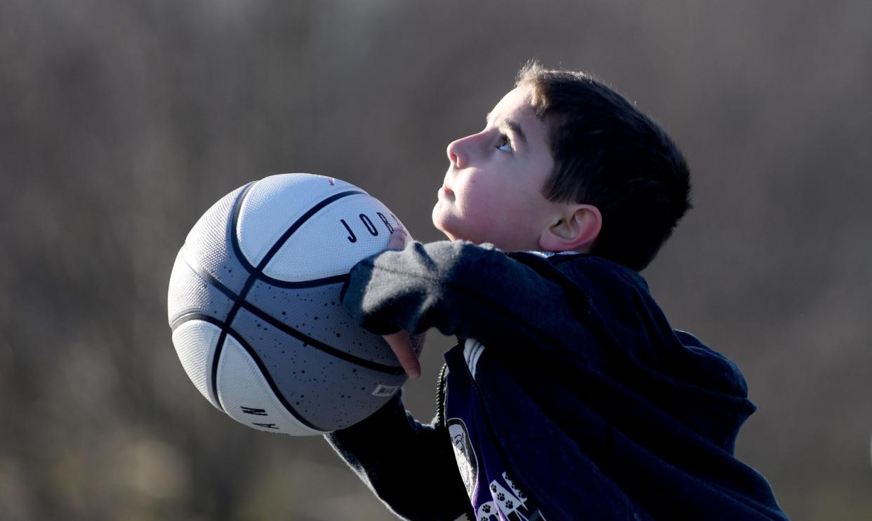 Maddox Wright, 5, lines up a shot on an unseasonably warm winter day at North Park in Jackson Township.