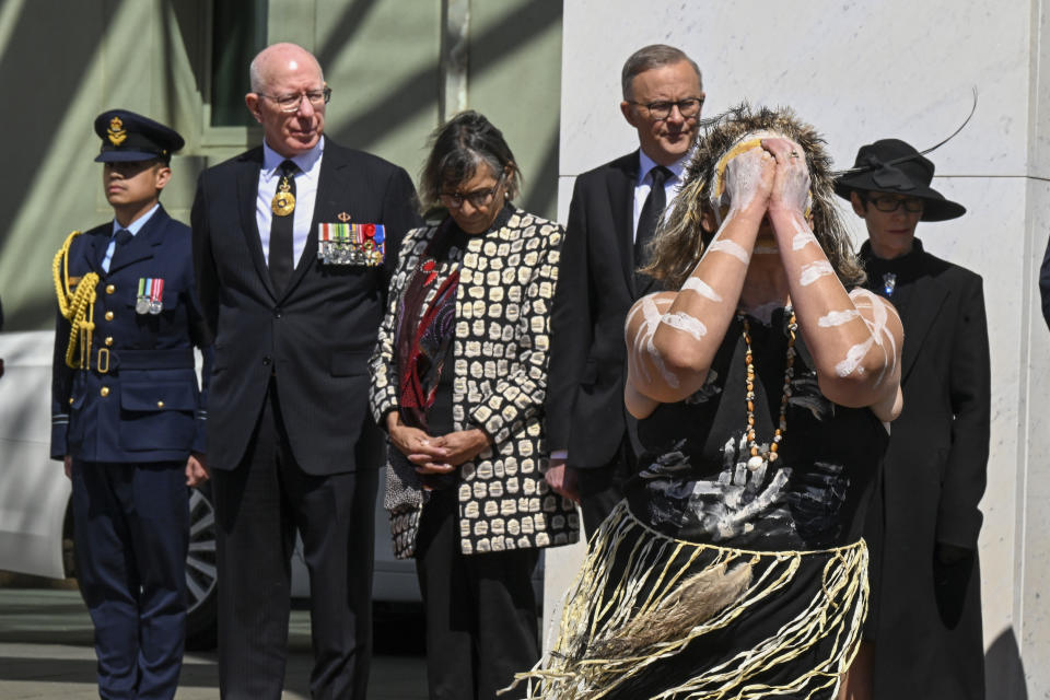 An indigenous dancer performs as Governor-General David Hurley, second left, and Prime Minister Anthony Albanese watch at the Proclamation of King Charles III, on the forecourt of Parliament House, in Canberra, Sunday, Sept. 11, 2022. The monarch's representative in Australia will proclaim the ascension of King Charles III as mourning continues around the nation for Queen Elizabeth II who died on Sept. 8, 2022. She was 96. (AAP Image/Mick Tsikas)