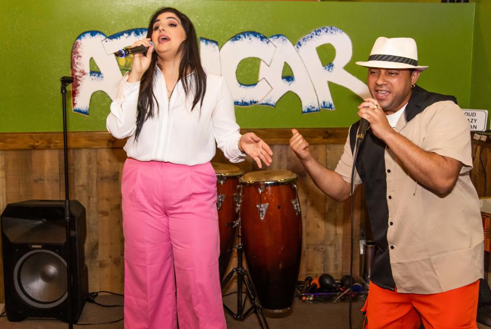 Mariolis Suarez, left, and Jurisan Moreno Rodrigues, right, perform on Friday night, March 22, at the Latin American Cafe in NE Ocala.