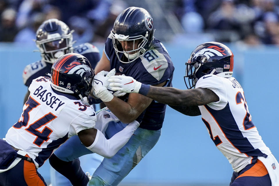 Tennessee Titans tight end Austin Hooper (81) runs into Denver Broncos cornerback Essang Bassey (34) during the second half of an NFL football game, Sunday, Nov. 13, 2022, in Nashville, Tenn. (AP Photo/Mark Humphrey)