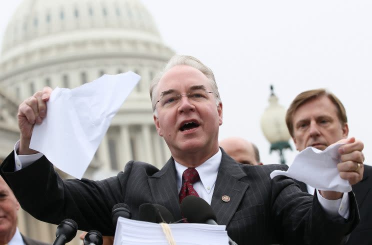 Rep. Tom Price, R-Ga., tears a page from the national health care bill during a press conference at the U.S. Capitol in 2012. (Photo: Win McNamee/Getty Images)