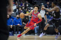 Detroit Pistons guard Cade Cunningham (2) drives past Sacramento Kings guard De'Aaron Fox (5) during the first quarter of an NBA basketball game in Sacramento, Calif., Wednesday, Jan. 19, 2022. (AP Photo/José Luis Villegas)