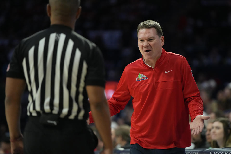 Arizona head coach Tommy Lloyd, right, talks to an official, left, during the first half of an NCAA college basketball game against Morgan State, Monday, Nov 6, 2023, in Tucson, Ariz. (AP Photo/Rick Scuteri)