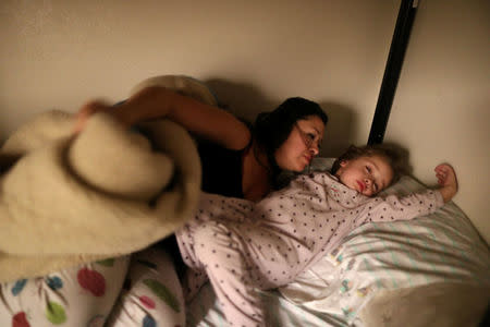 Yuritzy Quinones, 29, (L) wakes up her daughter Anaiah Garcia, 4, in Los Angeles, California, U.S. March 22, 2018. REUTERS/Lucy Nicholson