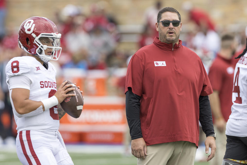 Oklahoma offensive coordinator Jeff Lebby watches quarterback Dillon Gabriel (8) warm up before an NCAA college football game against Tulsa, Saturday, Sept. 16, 2023, in Tulsa, Okla. (AP Photo/Alonzo Adams)