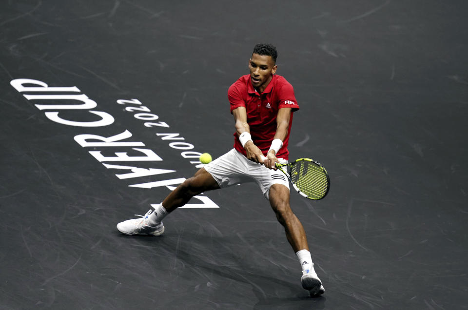 Team World's Felix Auger-Aliassime, of Canada, returns a ball to Team Europe's Matteo Berrettini, of Italy, during a match on the second day of the Laver Cup tennis tournament at the O2 in London, Saturday, Sept. 24, 2022. (John Walton/PA via AP)