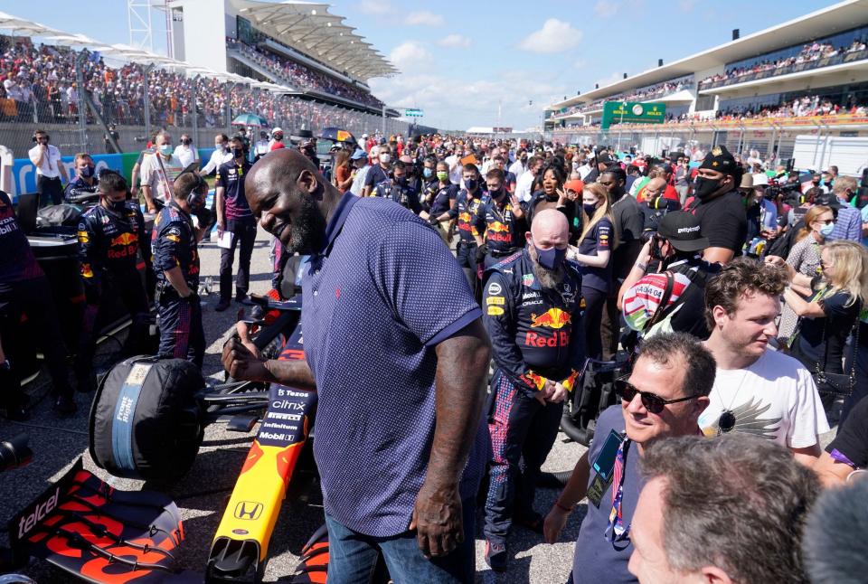 Shaquille O'Neal greets people in the pit lane before the Formula One United States Grand Prix at the Circuit of The Americas in Austin, Texas