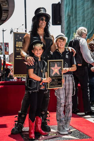 <p>Chelsea Lauren/WireImage</p> Slash with kids Cash Hudson and London Hudson in 2012