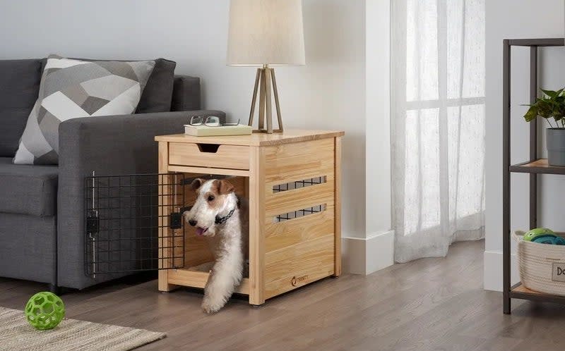 a dog exiting the crate in natural which is also being used as a side table