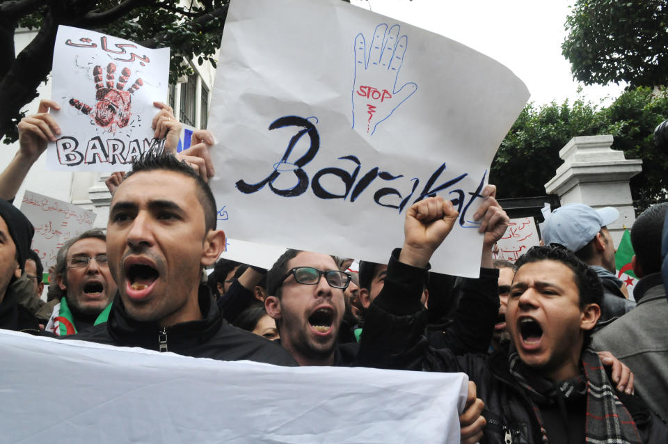 Demonstrators from the "Barakat!" ("Enough") group, protest during a rally against Algerian President Abdelaziz Bouteflika, Saturday, March 15, 2014 in Algiers. About 100 Algerian activists from a new anti-government movement staged a rare protest Saturday against the ailing president and his decision to run for a fourth term. Elections will take place on April 17, 2014. ( AP Photo/Ouahab Hebbat)