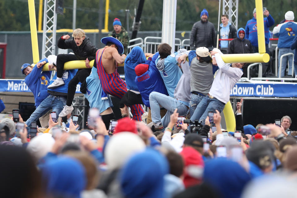 Jubilant Jayhawks fans tore down the goalpost and threw it in the lake after their upset victory. (Scott Winters/Icon Sportswire via Getty Images)