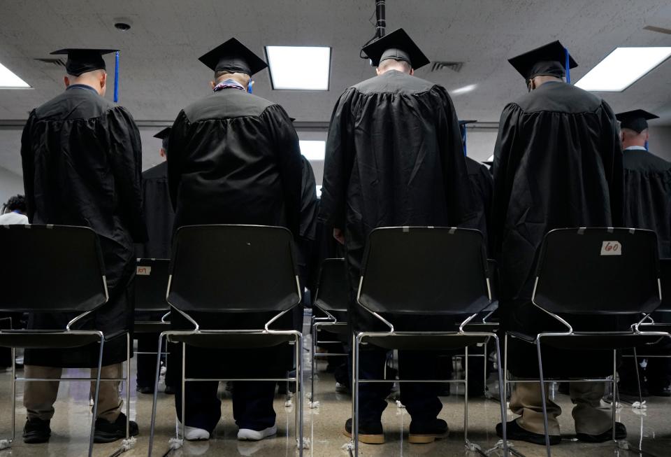 Dressed in caps and gowns, several dozen men and guests filled the chapel at Grafton Correctional Institution for a college graduation ceremony for those who had completed the requirements to earn associate or bachelors degrees from Ashland University.