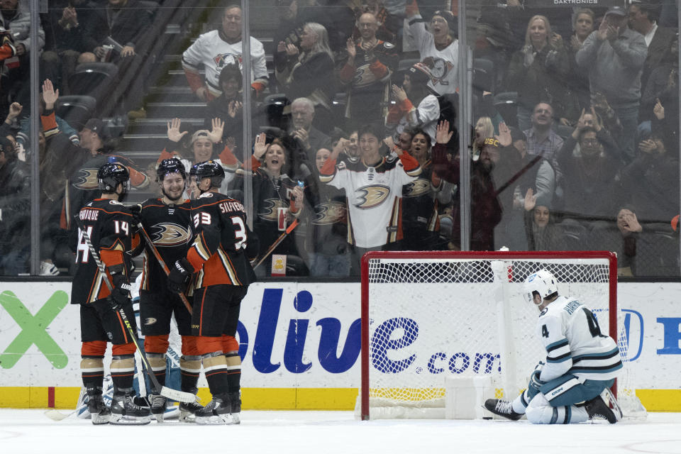 Anaheim Ducks center Mason McTavish, second from left, celebrates his goal with center Adam Henrique (14) and right wing Jakob Silfverberg (33) during the second period of the team's NHL hockey game against the San Jose Sharks in Anaheim, Calif., Friday, Jan. 6, 2023. (AP Photo/Kyusung Gong)