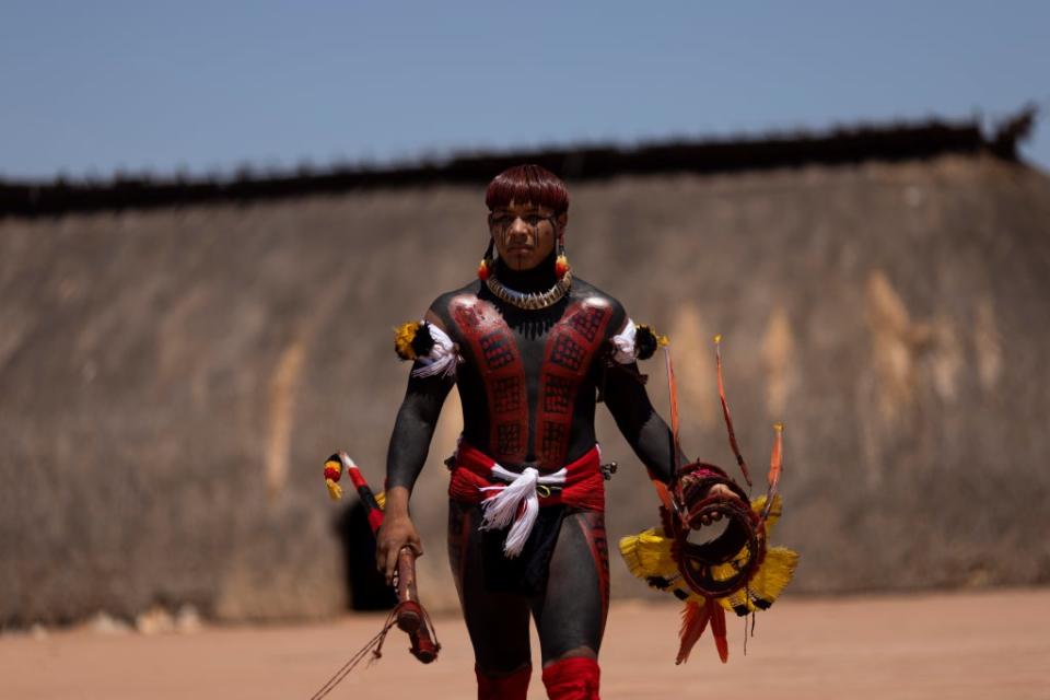 Kahugui, a Yawalapiti man, carries a panache (headdress) (Reuters)