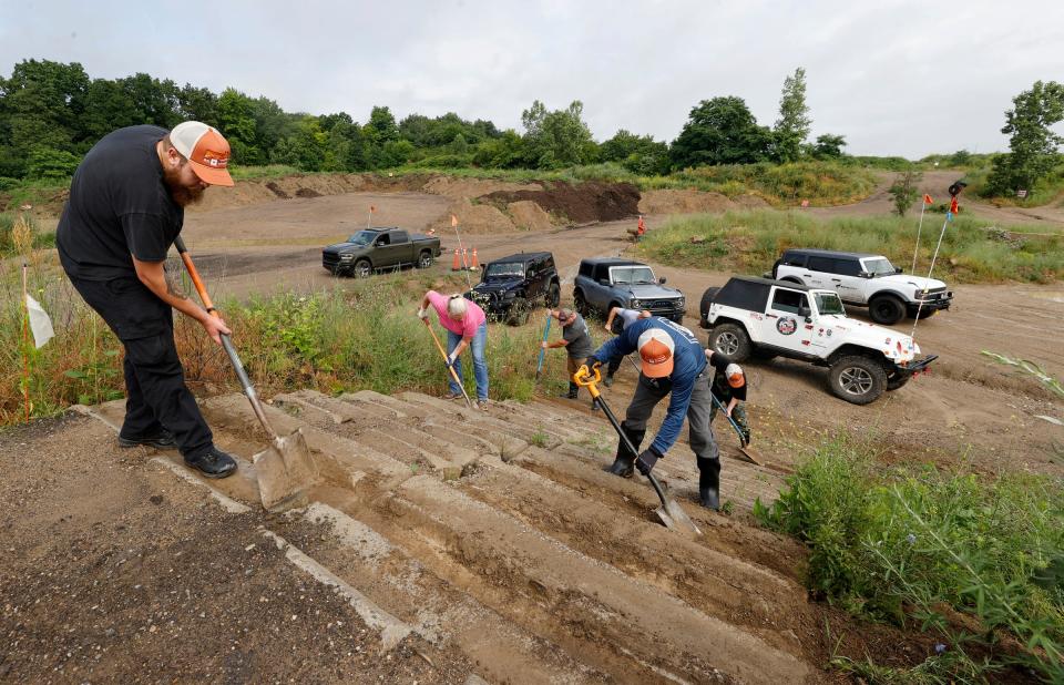 (Left) Kyle Stone, 29, of Howell, and others clear dirt from concrete steps used by off-road vehicles at the Tread Lightly event at Holly Oaks ORV Park in Holly on Saturday, June 29, 2024.
A group of off-road enthusiasts cleaned up and did trail maintenance at the event.