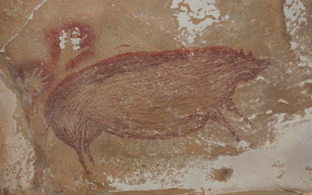 Archaeologists have discovered the world's oldest known cave painting: a life-sized picture of a wild pig that was made at least 45,500 years ago in Indonesia - Maxime Aubert/AFP