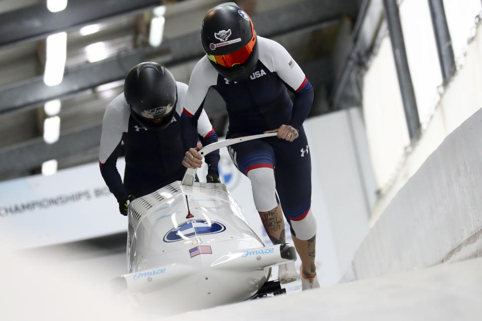 FILE - In this Feb. 5, 2021, file photo, Kaillie Humphries and Lolo Jones, of the United States, start during the two-women's bobsled race at the Bobsled and Skeleton World Championships in Altenberg, Germany. Reigning women’s world bobsled champion and three-time Olympic medalist Humphries has asked the International Olympic Committee for a solution that would allow her to compete in this winter’s Beijing Games even though her American citizenship will not be finalized. (AP Photo/Matthias Schrader, File)