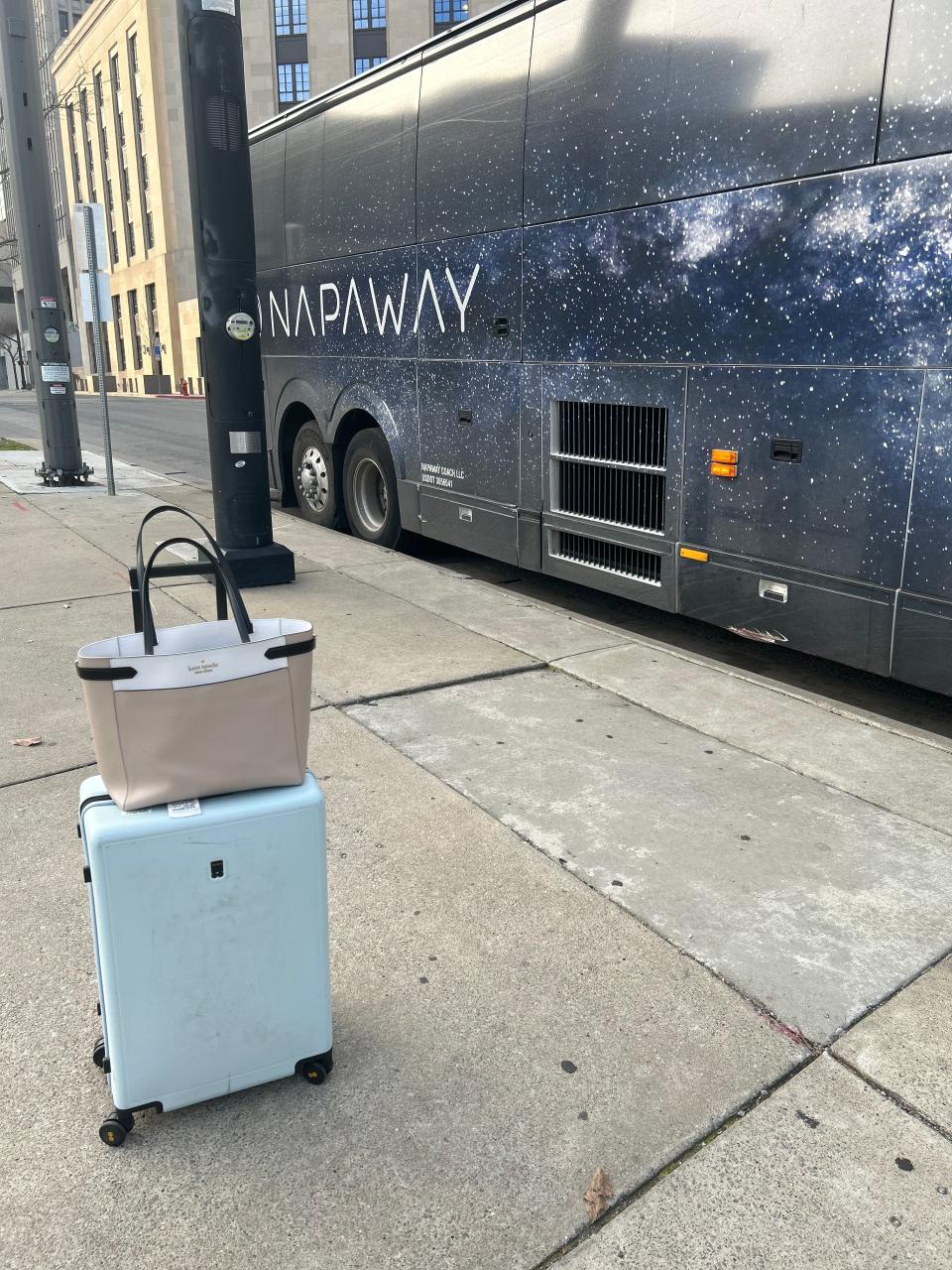 napaway bus with suitcases outside of it