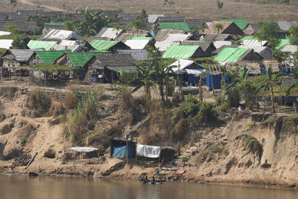 A camp for internally displaced people in Myanmar is seen across the Moei river from Mae Sot, Tak province, Thailand Monday, March 25, 2024. Thailand delivered its first batch of humanitarian aid to war-torn Myanmar sending ten trucks over the border from the northern province of Tak in what they hope will be a continuing effort to ease the plight of millions of people displaced by fighting. (AP Photo/Sakchai Lalit)