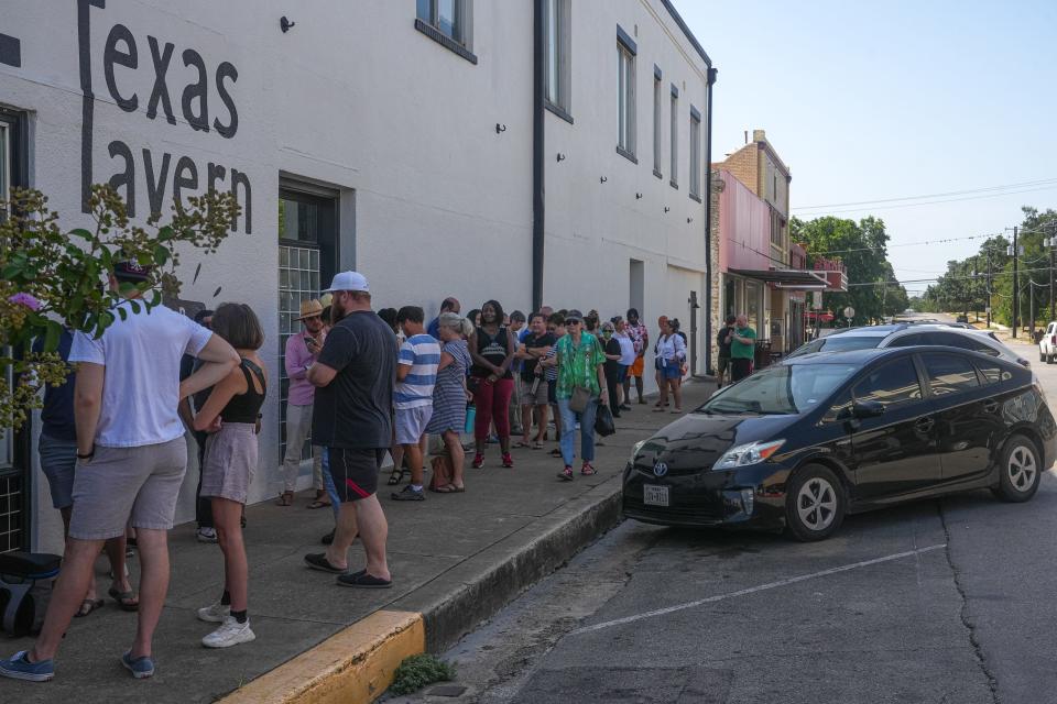 Customers line up outside Barbs-B-Q before the restaurant opens on July 29. The line usually forms before 10 a.m. for the restaurant that opens at 11 a.m. and closes when they sell out.