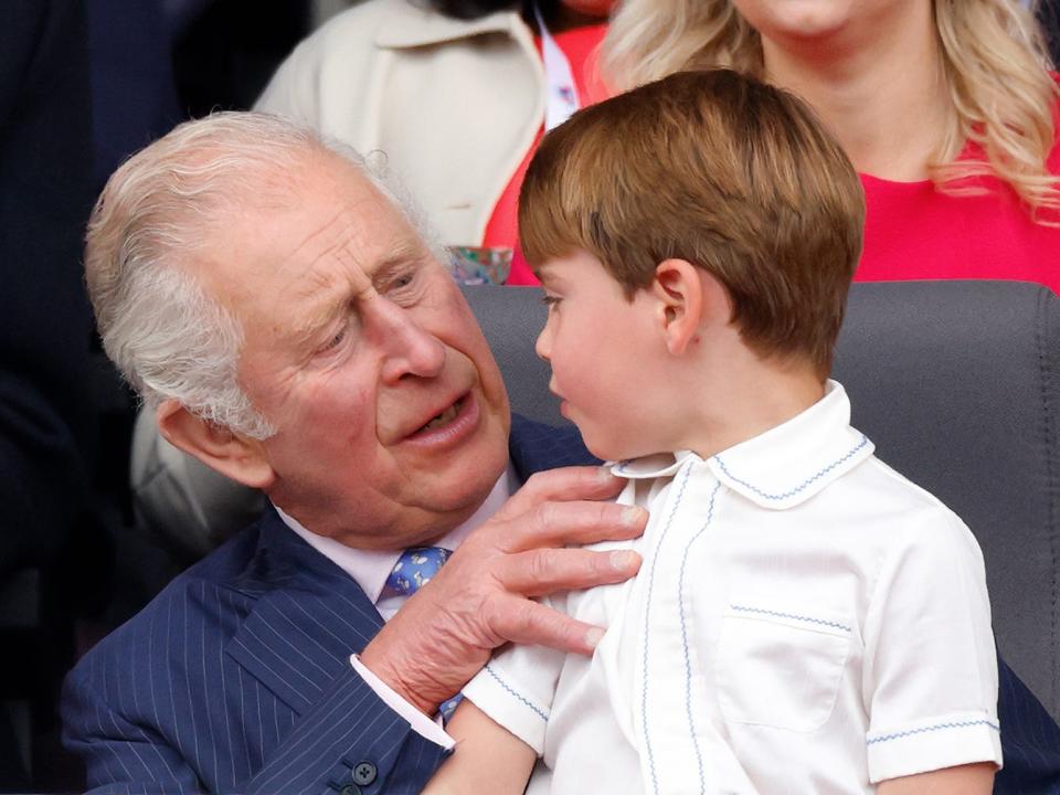 King Charles holds Prince Louis in his lap