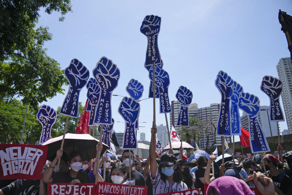 Protesters hold slogans during a rally against presidential frontrunner Ferdinand "Bongbong" Marcos and running mate Sara Duterte, daughter of the current president, during a rally in Pasay, Philippines, Friday, May 13, 2022. Allies of the Philippines' presumptive next president, Marcos Jr., appear set to strongly dominate both chambers of Congress, further alarming activists after the late dictator's son scored an apparent election victory that will restore his family to the seat of power. (AP Photo/Aaron Favila)