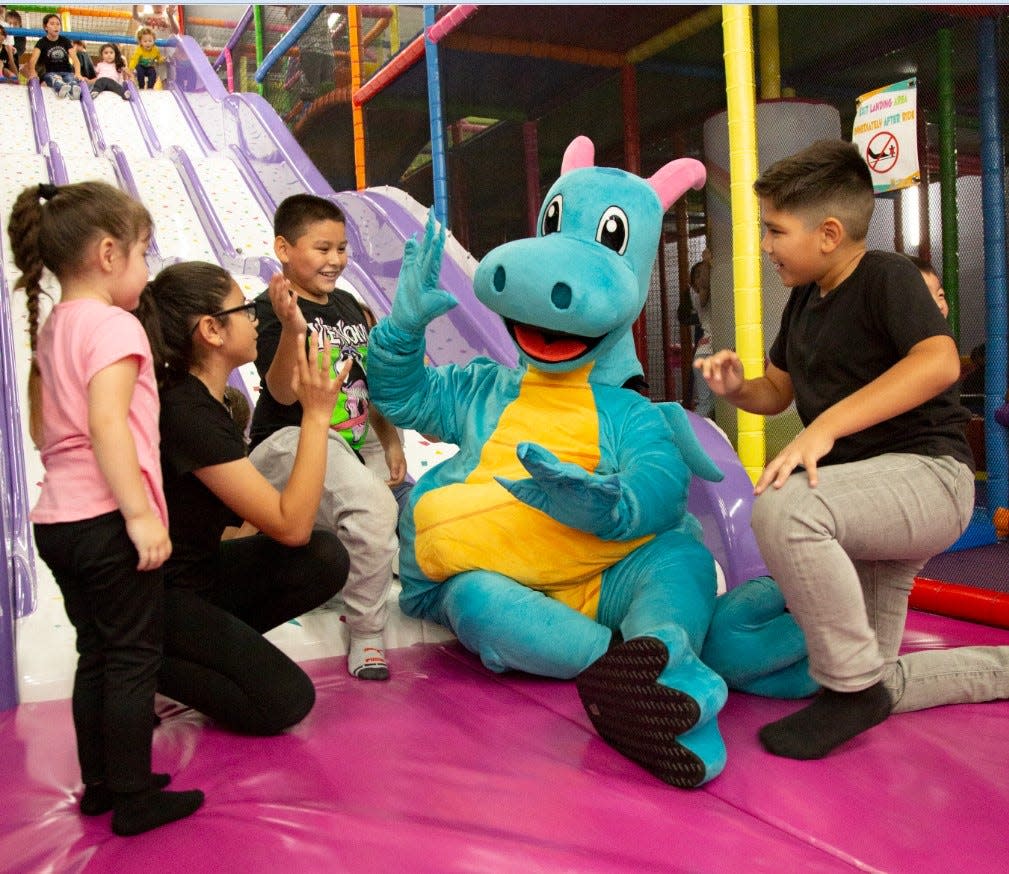Huggy, the dragon mascot of Kids Empire, greets children at one of the national chain's locations. The indoor playground operator is bringing a location to Summit Mall in Fairlawn.