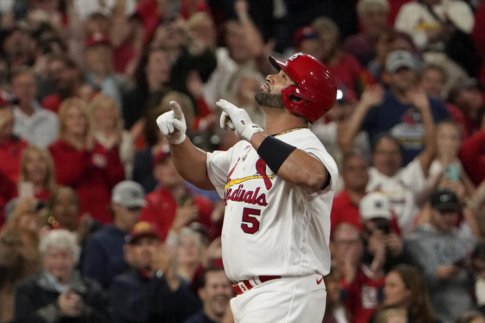 St. Louis Cardinals' Albert Pujols celebrates after hitting a solo home run during the fourth inning of a baseball game against the Pittsburgh Pirates Friday, Sept. 30, 2022, in St. Louis. (AP Photo/Jeff Roberson)
