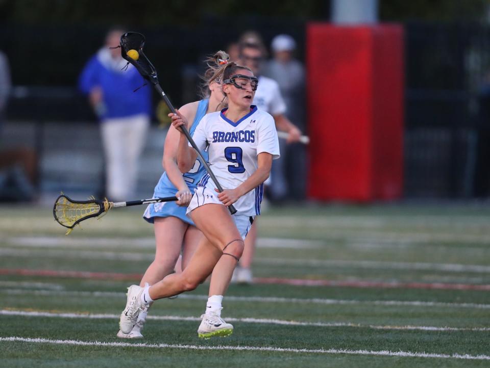 Bronxville's Caroline Ircha (9) works the ball across mid-field during their 16-7 win over Suffern in girls lacrosse action at Haindl Field in Eastchester on Friday, April 22, 2022.