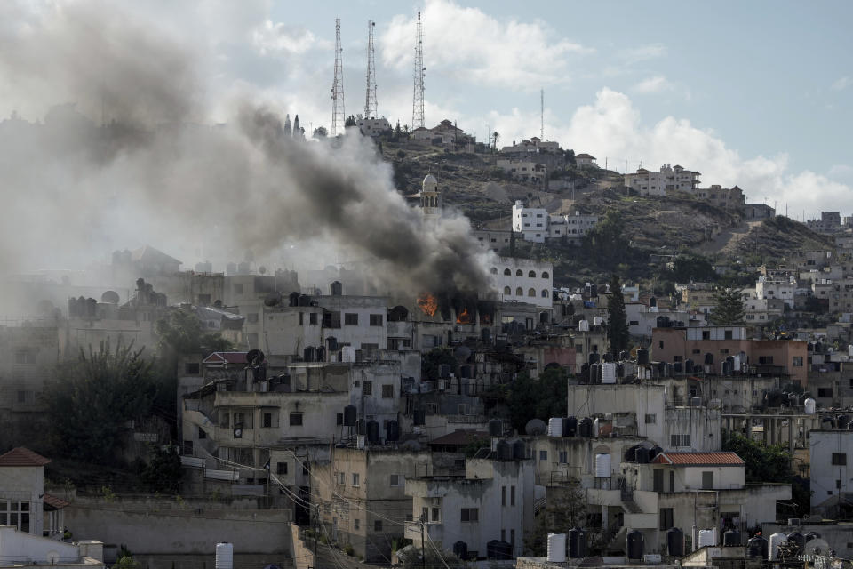 Fire and smoke rises during an Israeli army operation in Jenin, West Bank, Wednesday, Dec. 13, 2023. (AP Photo/Majdi Mohammed)