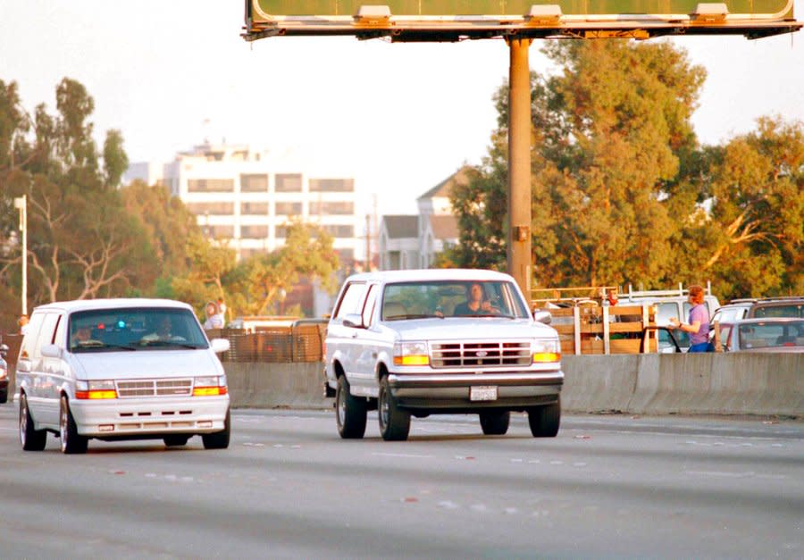 O.J. Simpson’s close friend Al Cowlings, at the wheel of a Ford Bronco with Simpson hiding, leads police on a two-county chase northbound 405 Freeway towards Simpson’s home, June 17, 1994, in Los Angeles. Simpson later surrendered to police and charged with two counts of murder in connection with the slayings of his ex-wife Nicole Brown Simpson and her friend Ronald Goldman. (AP Photo/Lois Bernstein)