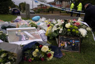 Flowers are laid near the Belfairs Methodist Church in Eastwood Road North, in Leigh-on-Sea, Essex, England, Saturday, Oct. 16, 2021 where British Conservative lawmaker David Amess died after being stabbed at a constituency surgery on Friday. Leaders from across the political spectrum came together Saturday to pay their respects to Amess who was stabbed to death in what police say was a terrorist-related attack. (AP Photo/Alberto Pezzali)