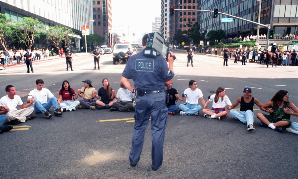 A Los Angeles Police Department official videotapes a rally to protest the University of California regents' decision to scrap affirmative action policies, on Oct. 12, 1995, in Los Angeles. (Chris Pizzello / AP file)