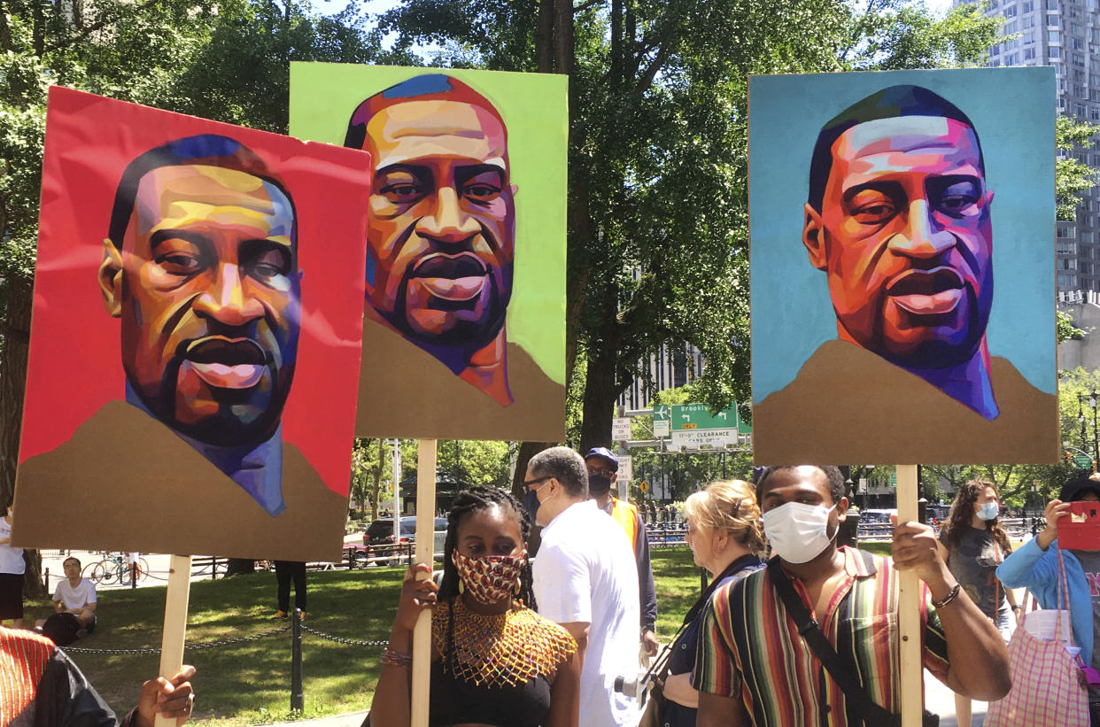 People carry images of George Floyd during a protest in lower Manhattan. (Credit: STRF/STAR MAX/IPx)