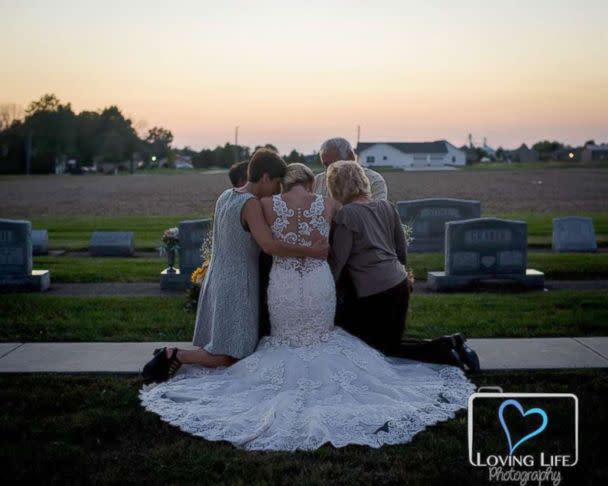 PHOTO: Jessica Padgett with her family hugging at Kendall Murphy&#39;s tombstone Providence Mennonite Church grave site, Sept. 29, 2018. (Mandi Kneep/Loving Life Photography)