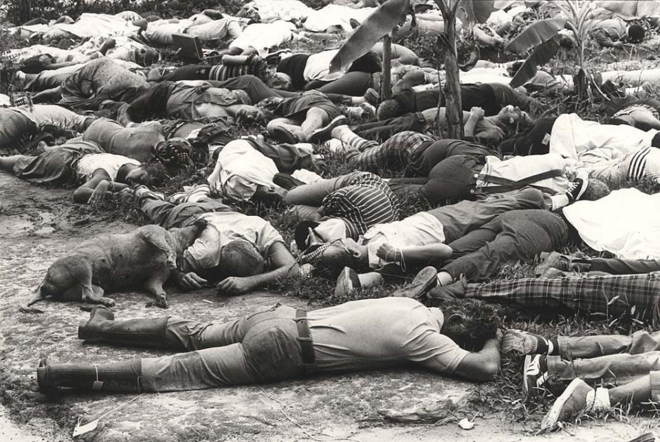 People lie on the ground dead from being forced to commit suicide. Over 900 people died by the direction of Rev. Jim Jones. <span class="copyright">Frank Johnston/The The Washington Post—Getty Images</span>