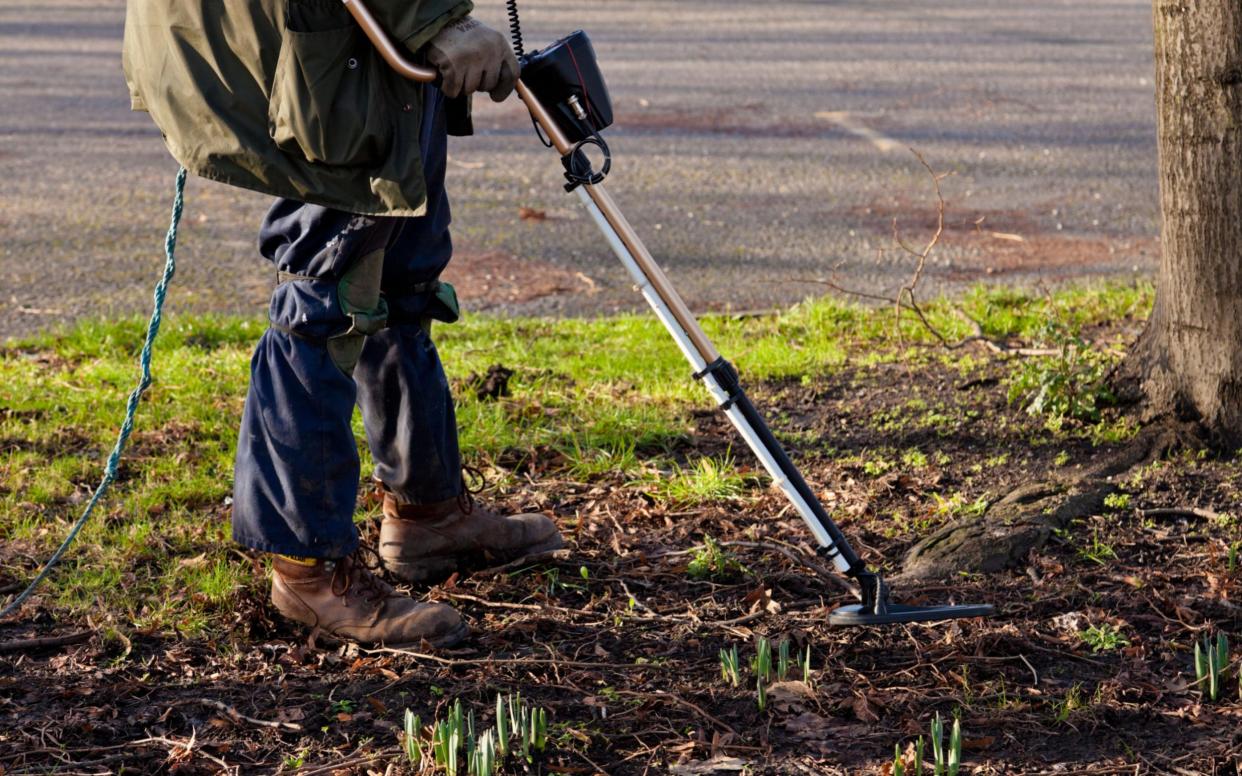 Metal detector being used by a detectorist - www.alamy.com