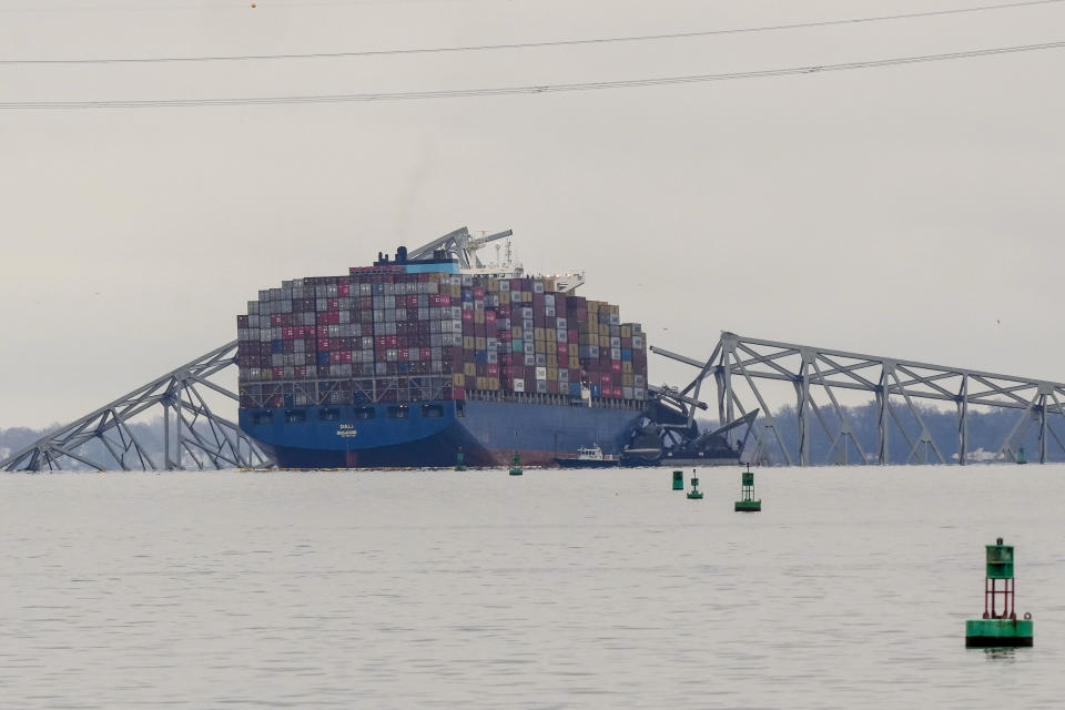 A container ship rests against wreckage of the Francis Scott Key Bridge on Wednesday, March 27, 2024, in Baltimore, Md. The ship rammed into the major bridge early Tuesday, causing it to collapse in a matter of seconds and creating a terrifying scene as several vehicles plunged into the chilly river below. (AP Photo/Matt Rourke)