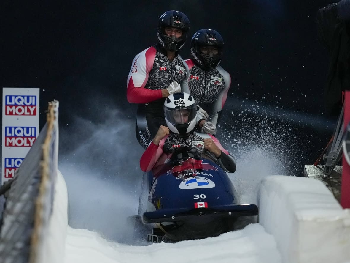 Canada's Taylor Austin, Shaquille Murray-Lawrence, Cyrus Gray, and Davidson De Souza, celebrate after racing to a third-place finish in Whistler on Nov. 26. (Darryl Dyck/Canadian Press - image credit)