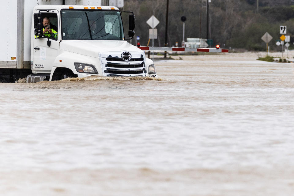 A truck drives through an area affected by floods after days of heavy rain in Pajaro, California, on March 14, 2023. 