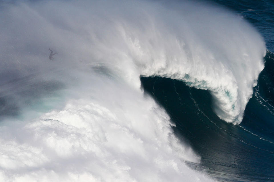 Big wave surfer at Nazare’s North Beach, Portugal