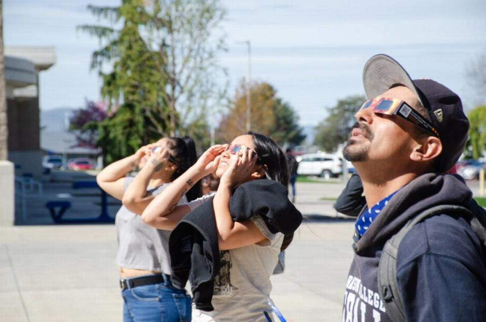 Students at Columbia Basin College in Pasco, Wash., stop to observe the 2024 North American total solar eclipse on Monday, April 8.