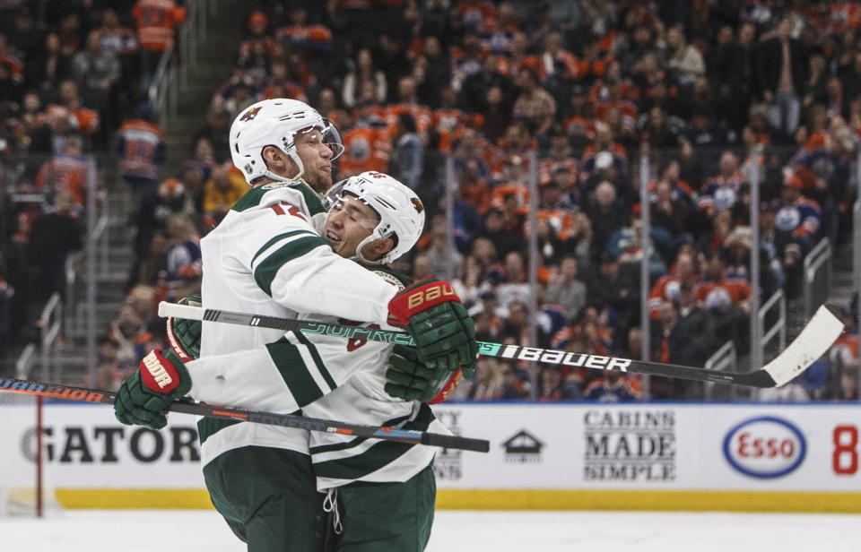 Minnesota Wild's Eric Staal (12) and Jared Spurgeon (46) celebrate a goal against the Edmonton Oilers during the third period of an NHL hockey game Friday, Feb. 21, 2020, in Edmonton, Alberta. (Jason Franson/The Canadian Press via AP)