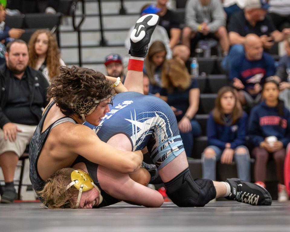 Tobby Rooney (left), of Jensen Beach, competes against Peter Mocco, of Coral Springs, in a semifinal during the Region 4-1A wrestling tournament, Saturday, Feb. 24, 2024, at Jensen Beach High School.