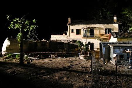 A train carriage is seen after crashing into a house following a train derailment, in the town of Adendro in northern Greece, May 13, 2017. REUTERS/Alexandros Avramidis