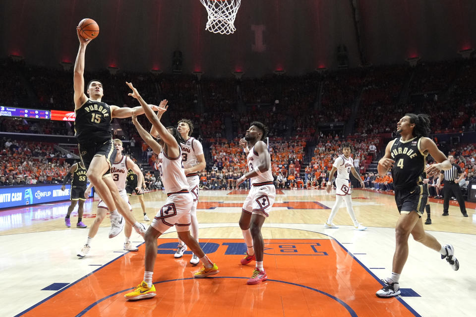 Zach Edey (15) shoots over Illinois' Ty Rodgers during the first half of an NCAA college basketball game Tuesday, March 5, 2024, in Champaign, Ill. (AP Photo/Charles Rex Arbogast)