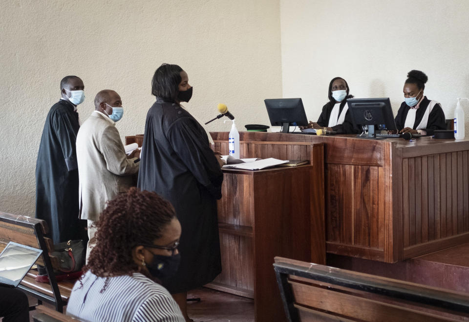 Paul Rusesabagina, 2nd left, who inspired the film "Hotel Rwanda" for saving people from genocide, appears at the Kicukiro Primary Court in the capital Kigali, Rwanda Monday, Sept. 14, 2020. Rusesabagina became famous for protecting more than 1,000 people as a hotel manager during Rwanda's 1994 genocide and was awarded the U.S. Presidential Medal of Freedom in 2005 but Rwandan authorities accused him of supporting the armed wing of his opposition political platform, which has claimed responsibility for deadly attacks inside Rwanda. (AP Photo)